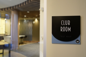 club room sign with braille for ada compliance